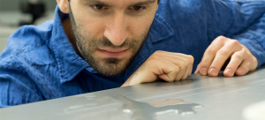 Engineering Assistant Professor Kevin Golovin observes water pooling on a superhydrophobic surface.